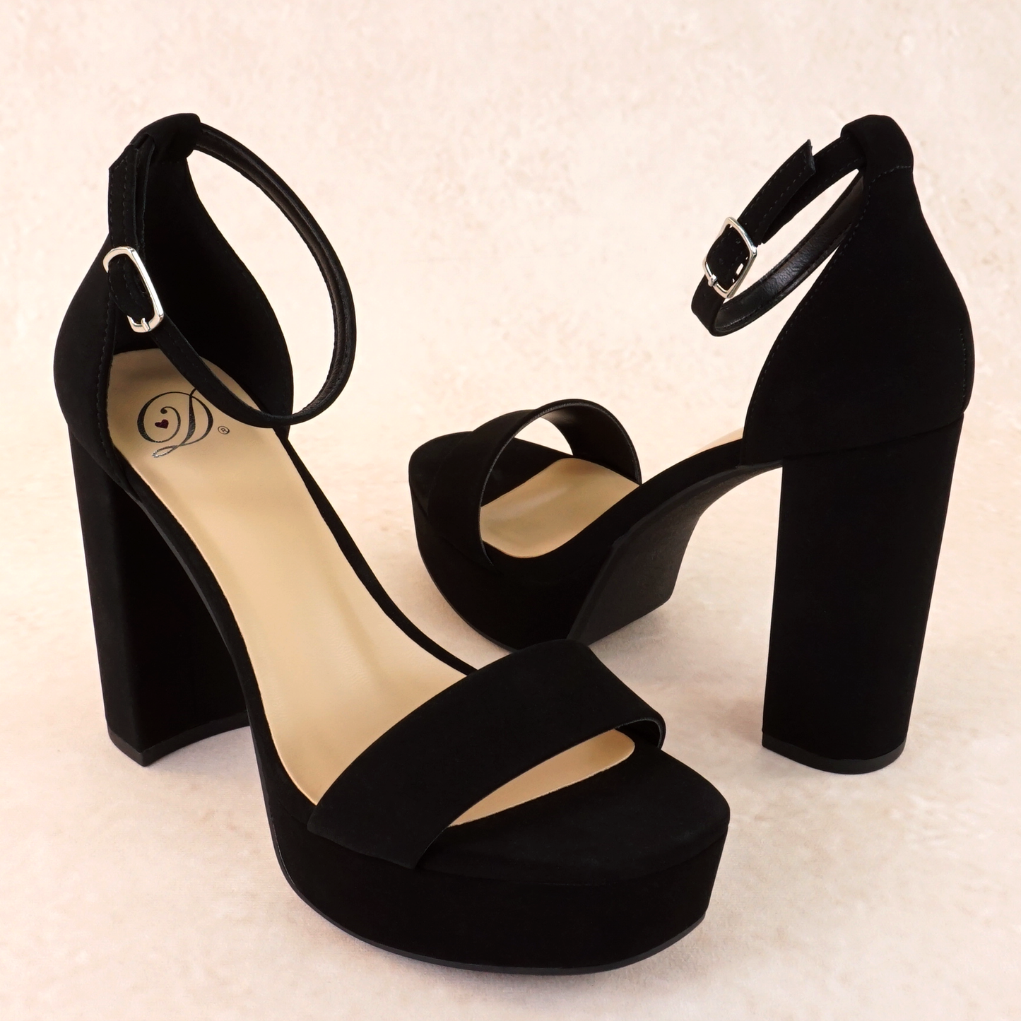 A black open-toe high block heel with a platform in a soft nubuck material, with an adjustable ankle strap and single strap across the toes