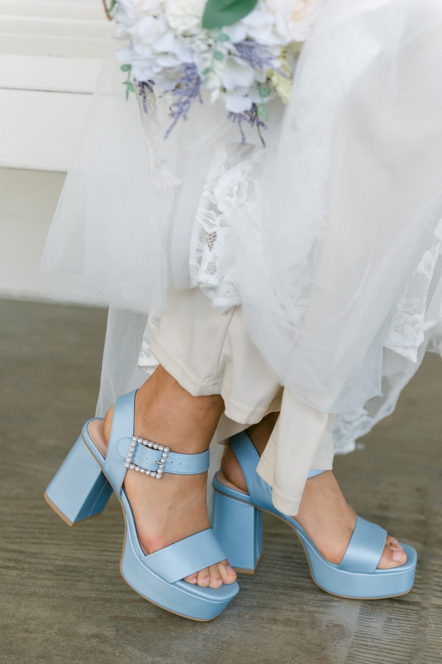 3.75" block heel in blue with 1.5" platform and a pearl detail buckle worn by a woman in a white dress