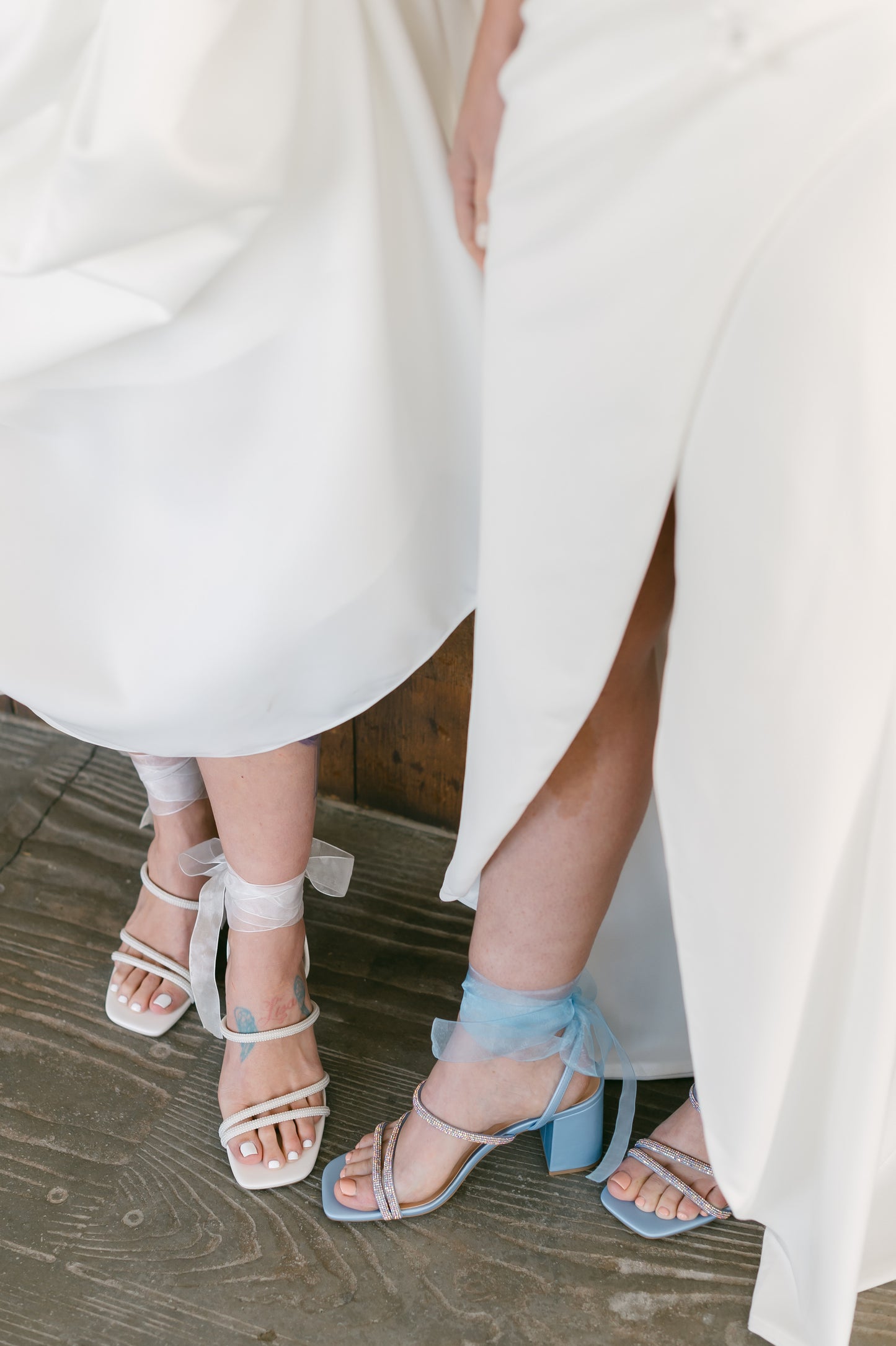 3.25" block heels in blue and white with rhinestone straps and a sheer ribbon ankle tie worn by two women in white dresses