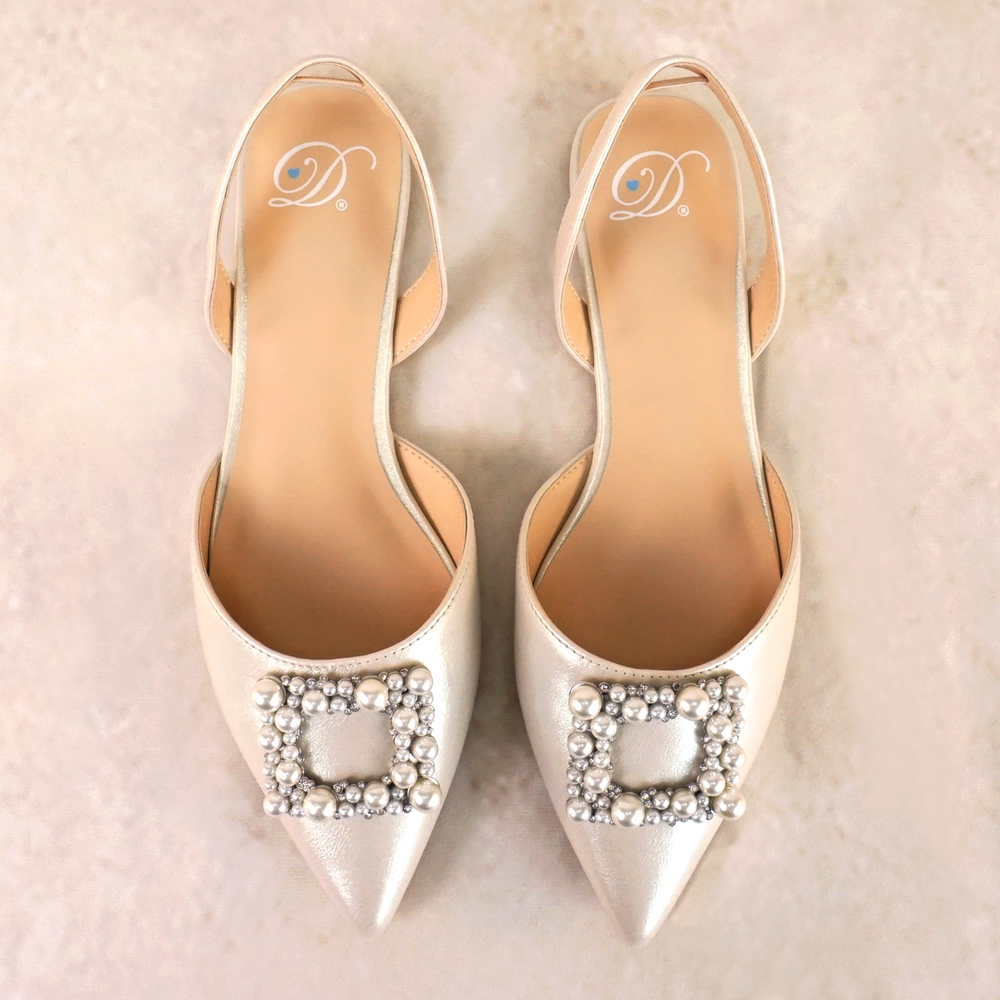 Slingback flat with a pearl buckle accent in a pearl shimmer