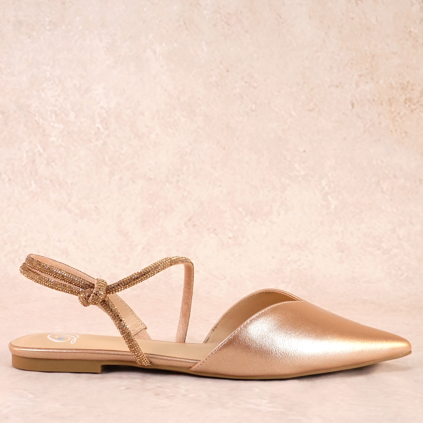 Pointed-toe slingback gold flat with rhinestone strap