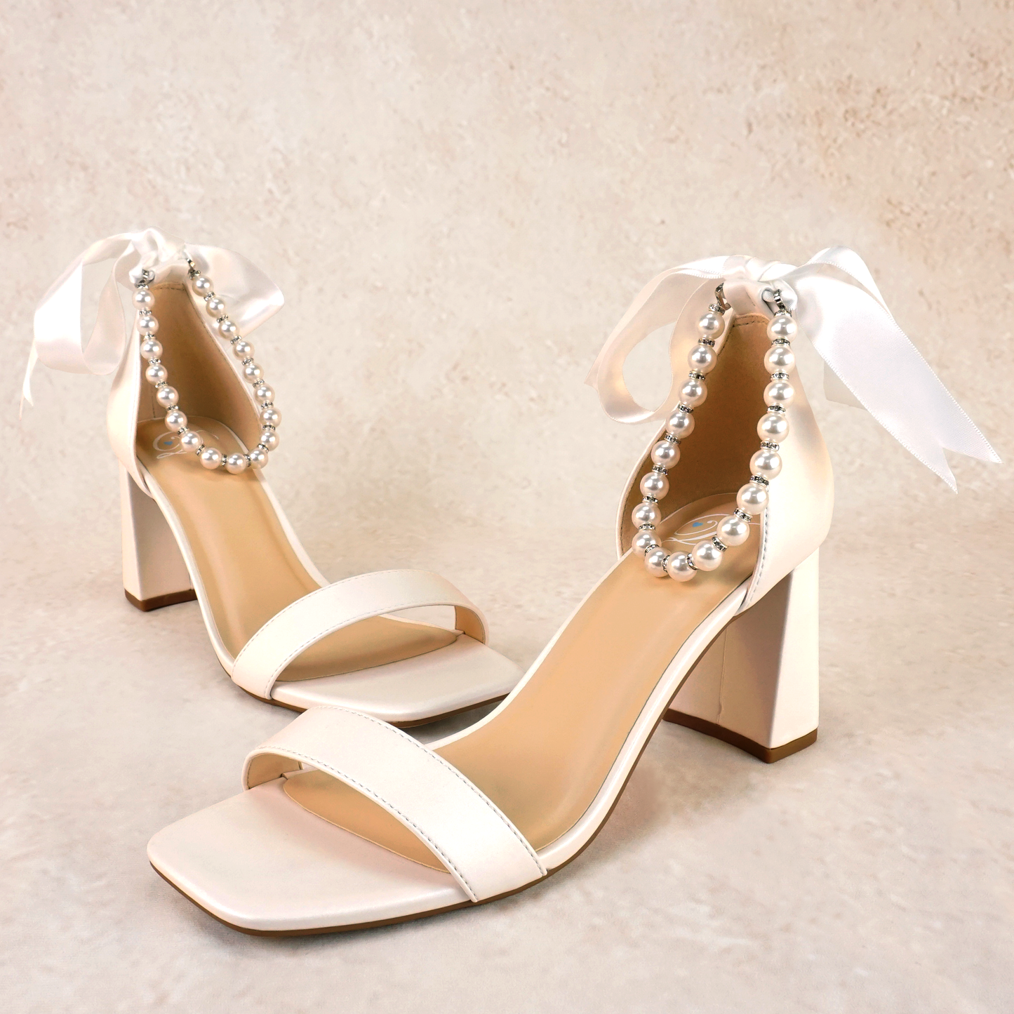 3" flared block heel in white with adjustable pearl ankle strap and satin ribbon tie