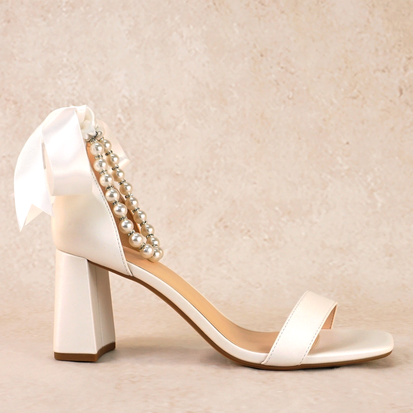 3" flared block heel in white with adjustable pearl ankle strap and satin ribbon tie