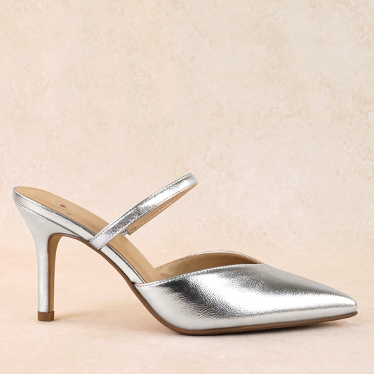 A silver closed-toe stiletto heel shoe in a shiny metallic material and an elasticized strap across the foot