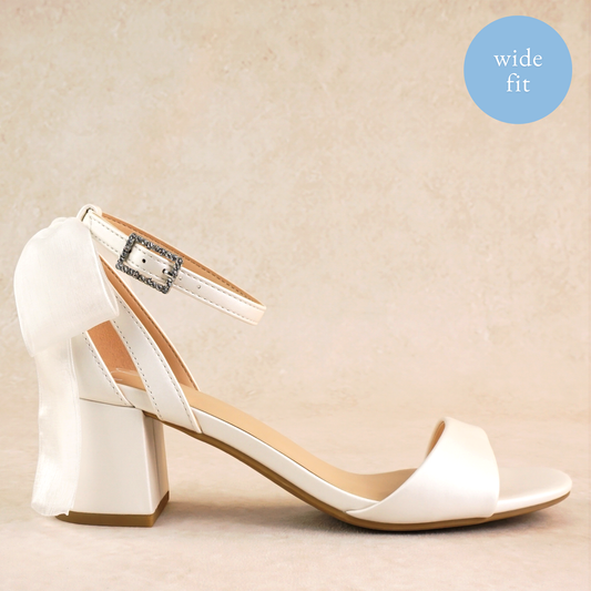 Wide fit simple low 2.5" block heel in white with a bow at the back