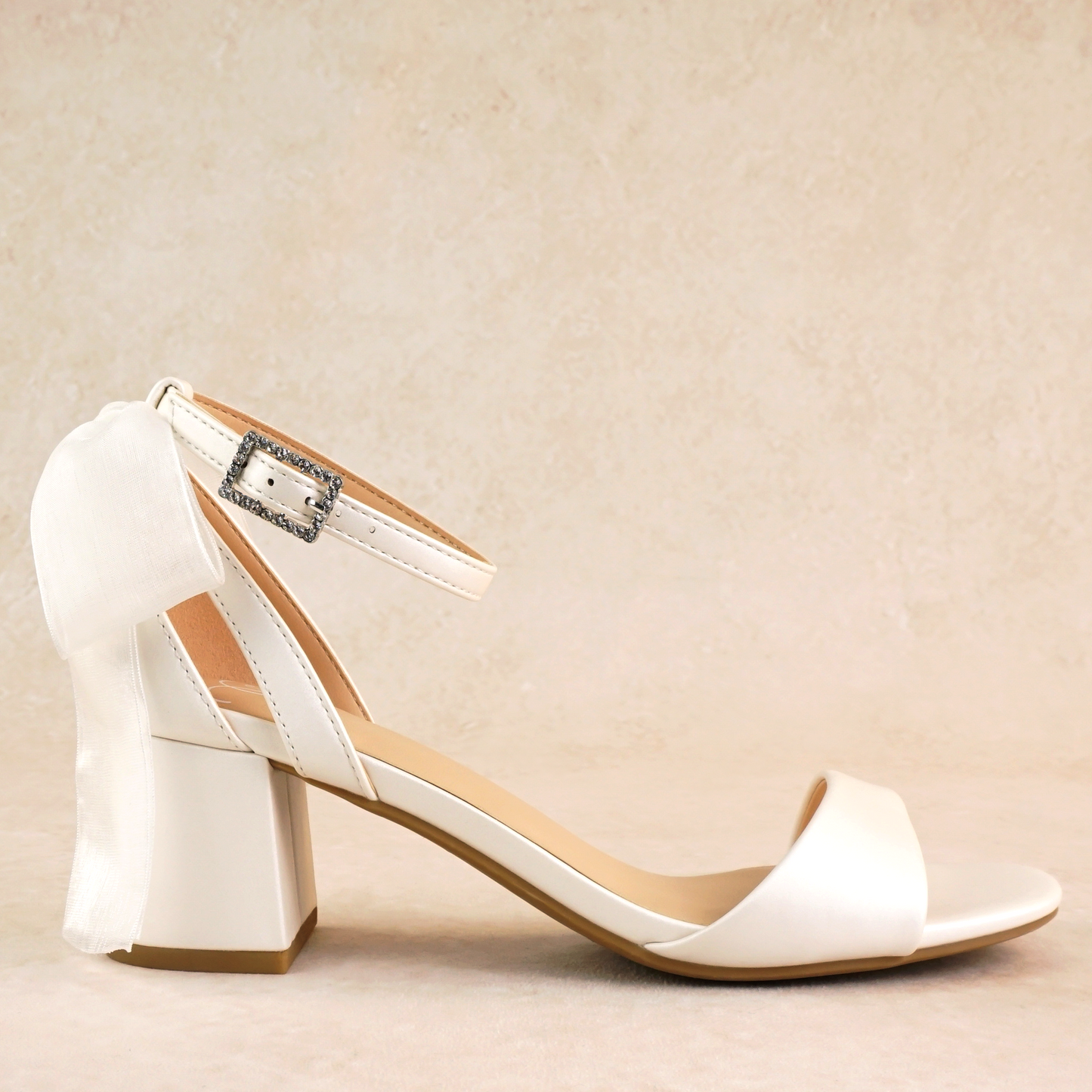 Simple low 2.5" block heel in white with a bow at the back