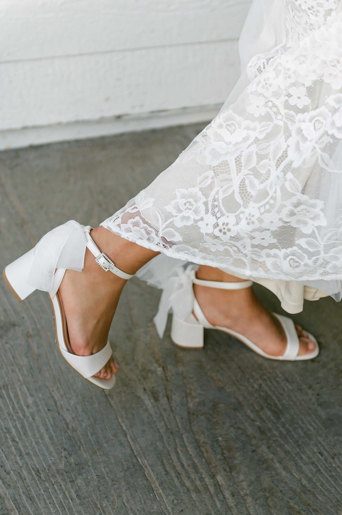 Simple low 2.5" block heel in white with a bow at the back