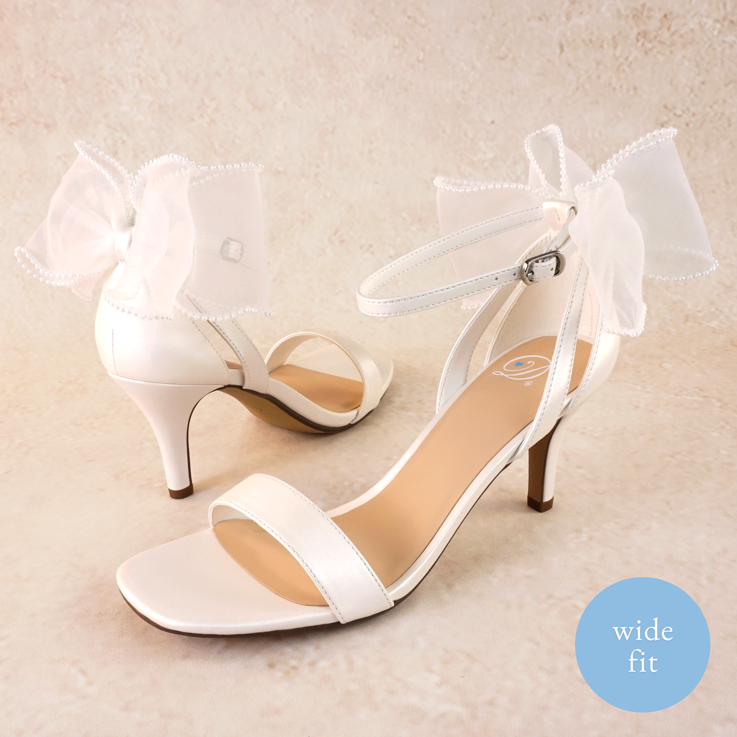 Wide fit simple single-band 3" stiletto heel in white with a beaded bow on the back