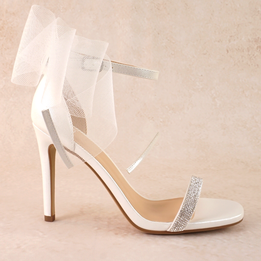 4" stiletto heel in white with rhinestone band and wire mesh statement bow