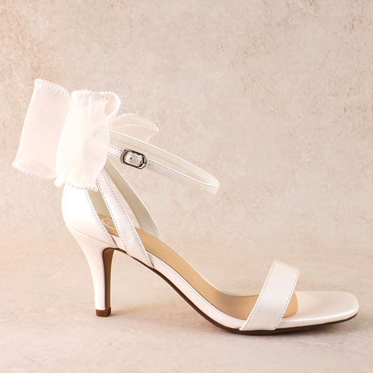 Simple single-band 3" stiletto heel in white with a beaded bow on the back