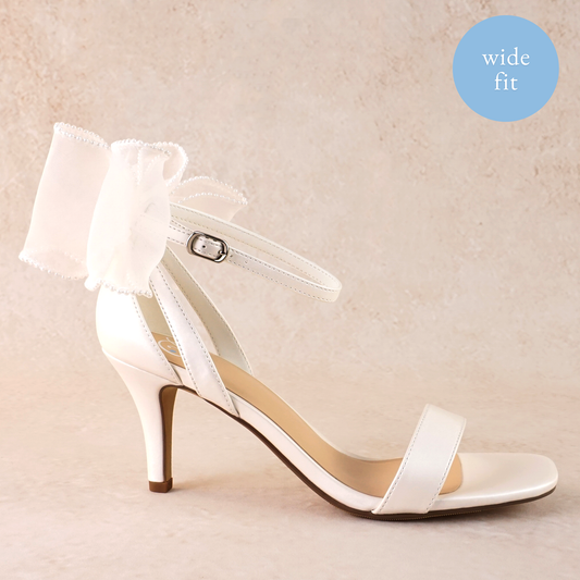 Wide fit simple single-band 3" stiletto heel in white with a beaded bow on the back