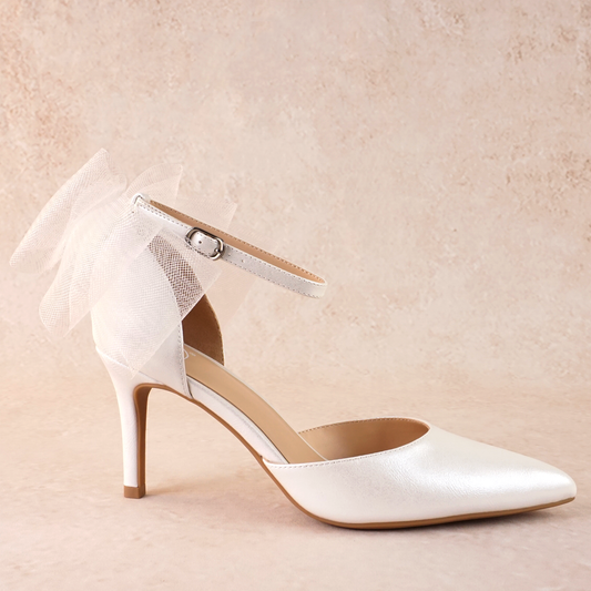 White d’orsay pump with ankle strap bow detail and a 3.25" stiletto heel