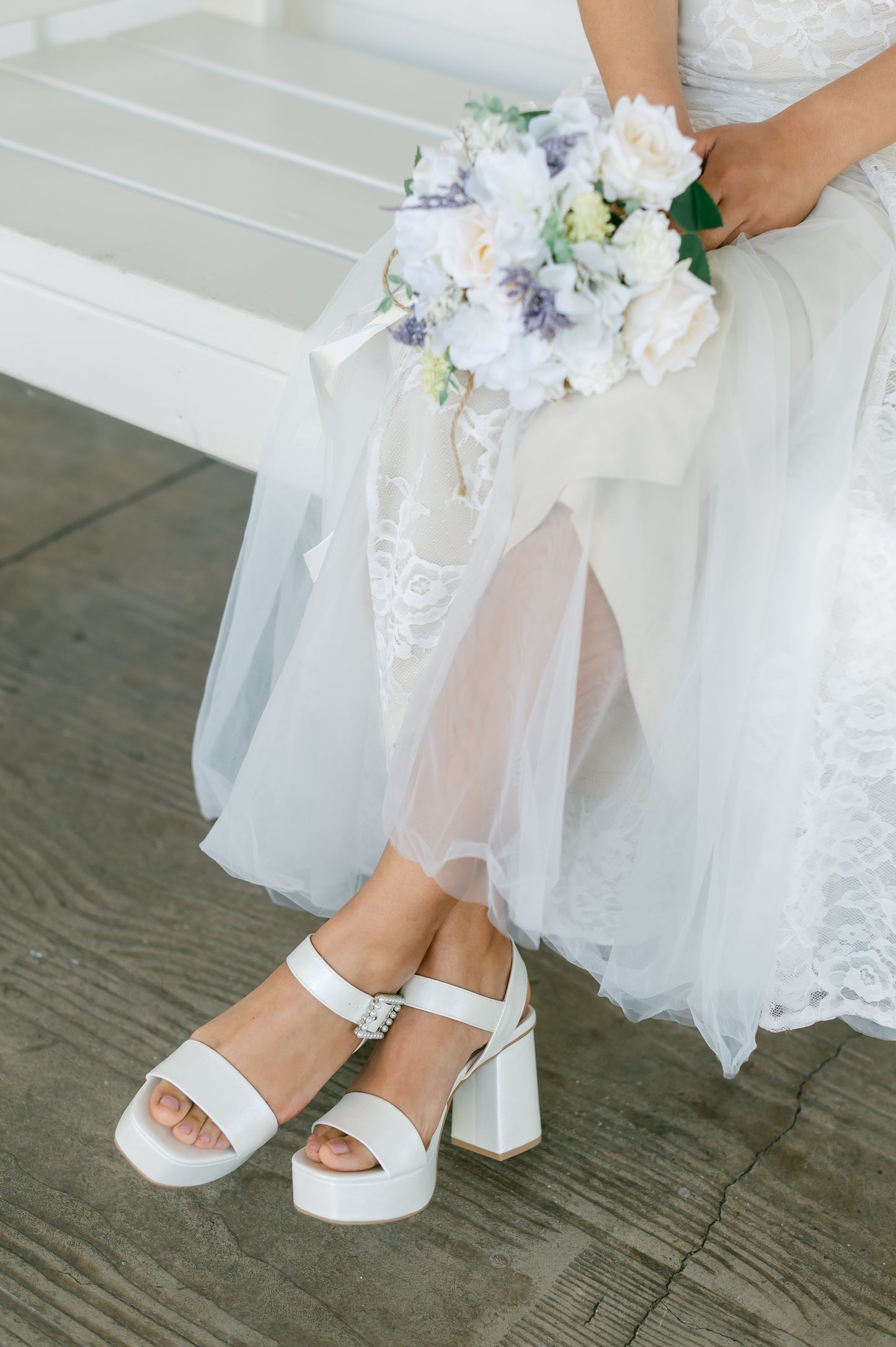 3.75" block heel in white with 1.5" platform and a pearl detail buckle worn by a woman in a white dress