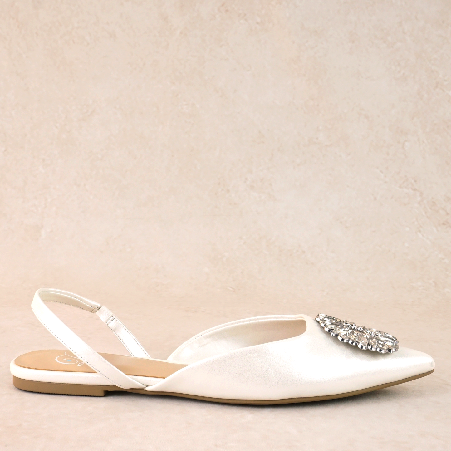 White pointed-toe slingback flat shoe with rhinestone accent