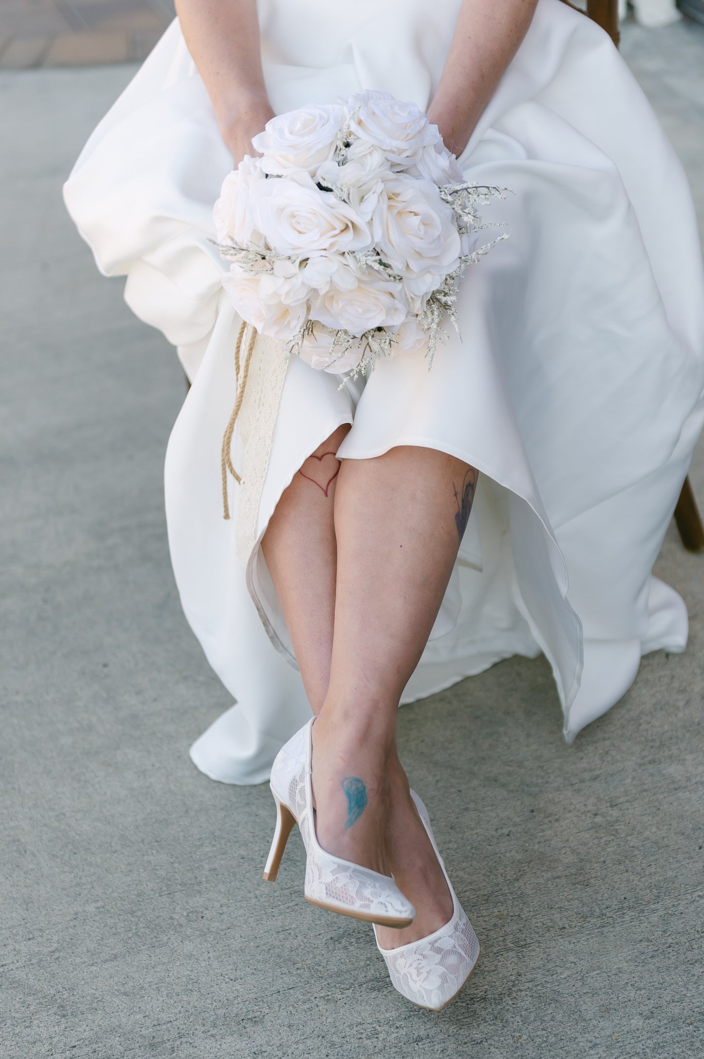 Classic white allover sheer lace stiletto pump with a 3.5" heel worn by a woman in a white dress