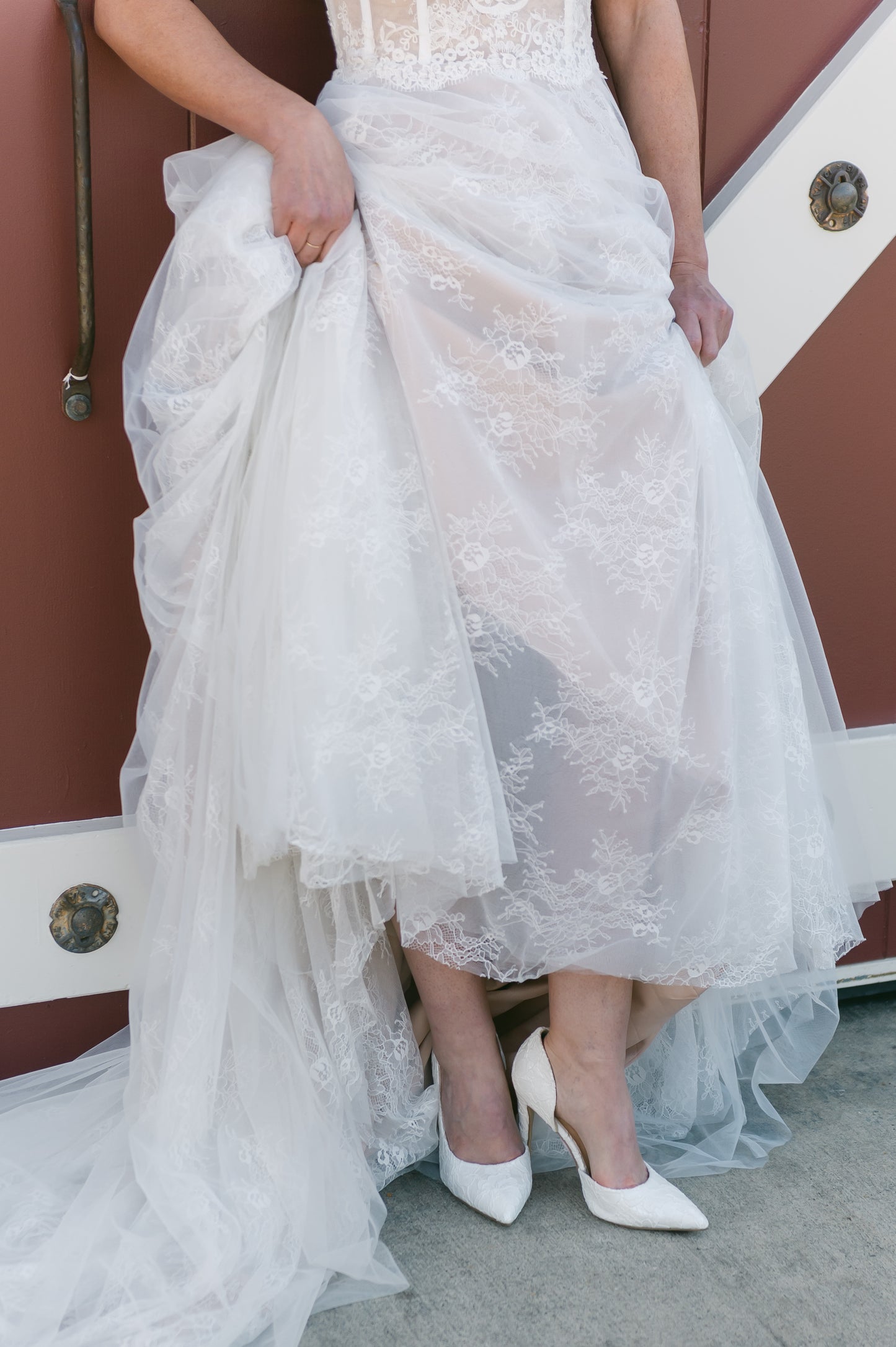 White lace d’orsay cut-out stiletto with a 4.25" heel worn by a woman in a white dress