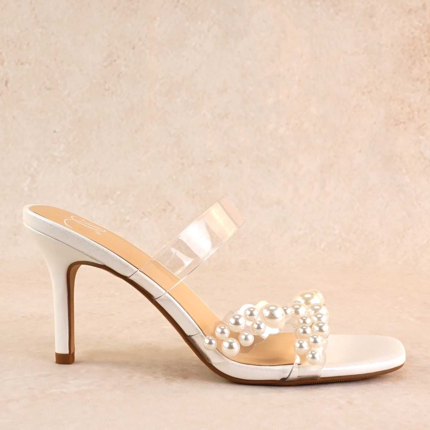 White stiletto slide with pearls on a lucite cross-strap with a 3.5" stiletto heel