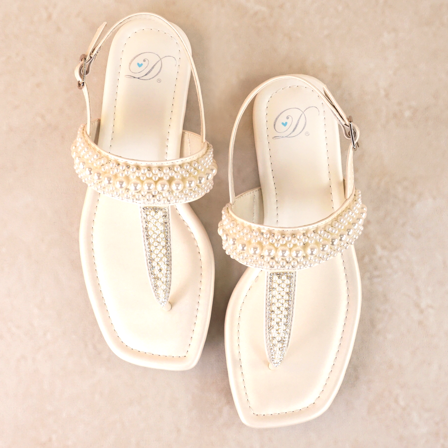 T-strap white sandals with adjustable slingback and pearl and rhinestone accents