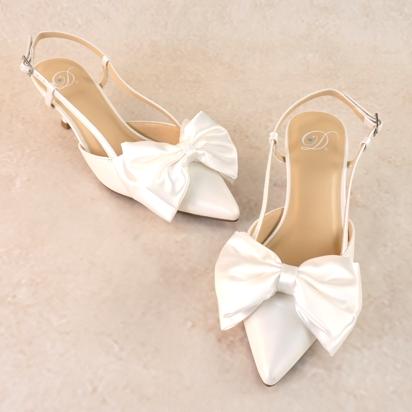 Classic white 2.25" kitten heel adjustable slingback with a satin bow
