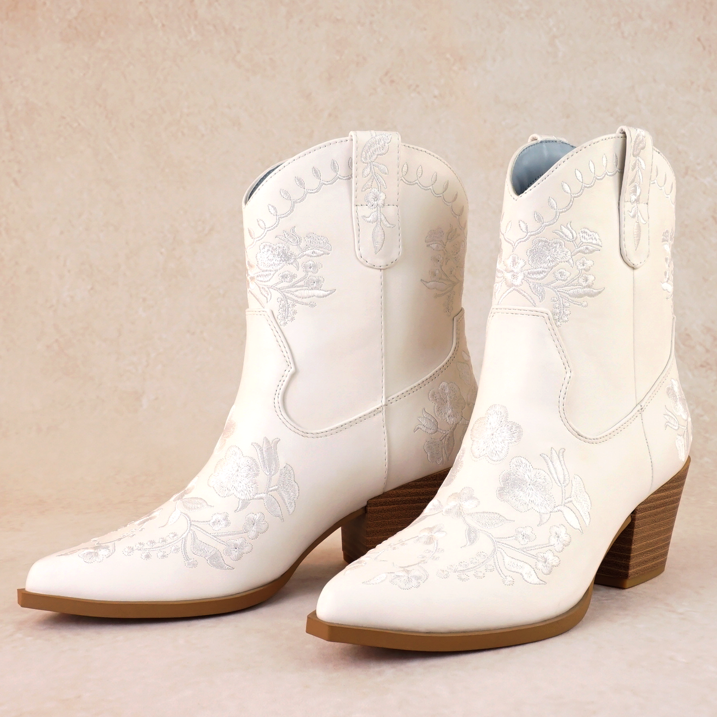 Western white bootie with embroidered flowers and a 2.75" stacked heel