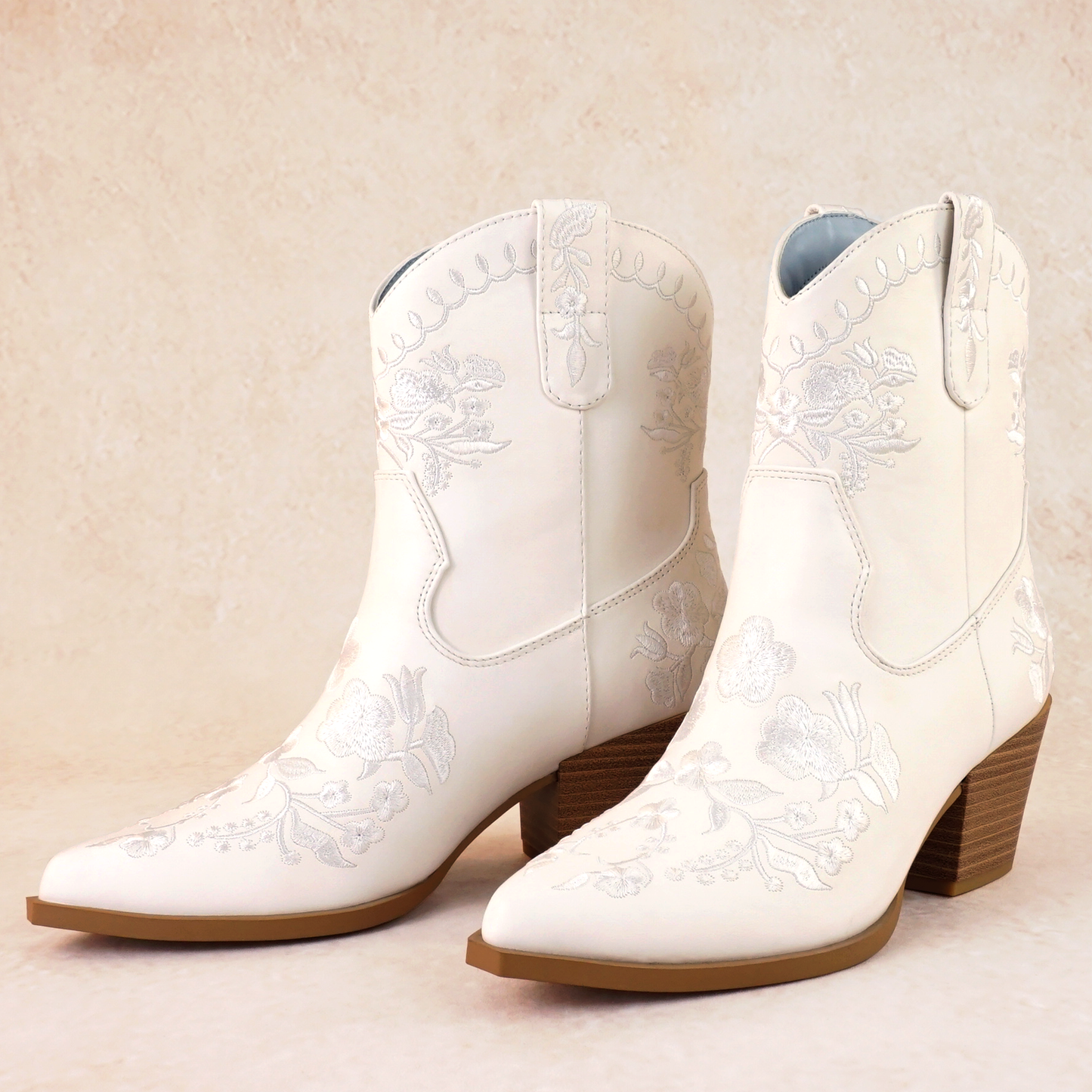 Western white bootie with embroidered flowers and a 2.75" stacked heel