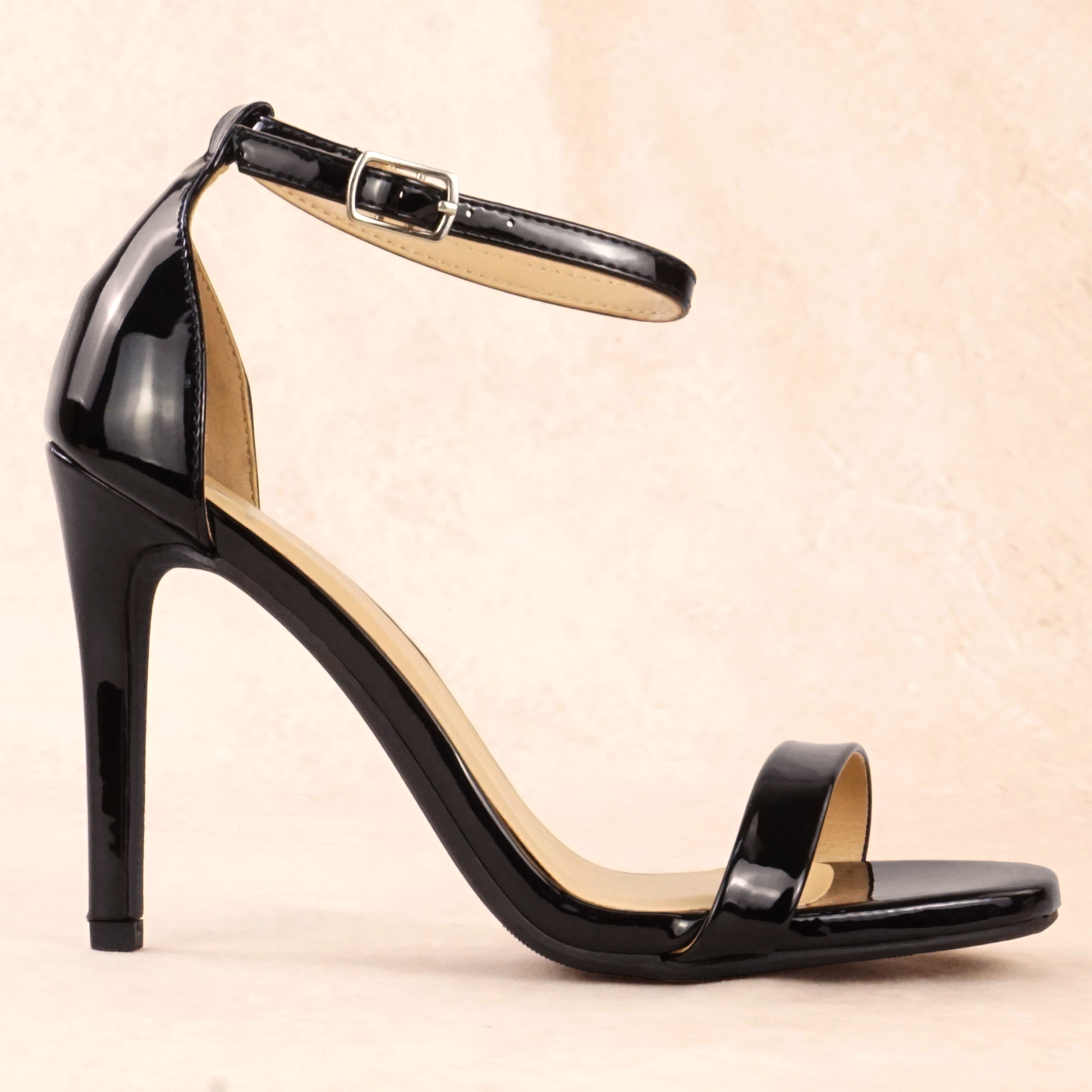 A black patent material stiletto heel with adjustable ankle strap
