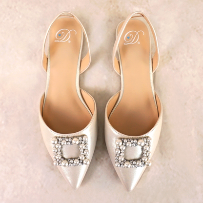 Slingback flat with a pearl buckle accent in a pearl shimmer