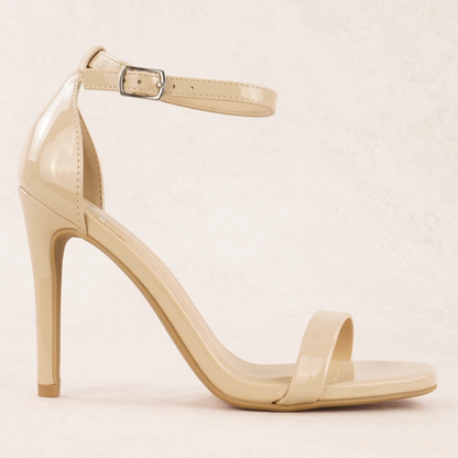 A dark beige patent material stiletto heel with adjustable ankle strap