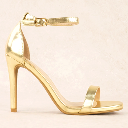 A gold metallic stiletto heel with adjustable ankle strap