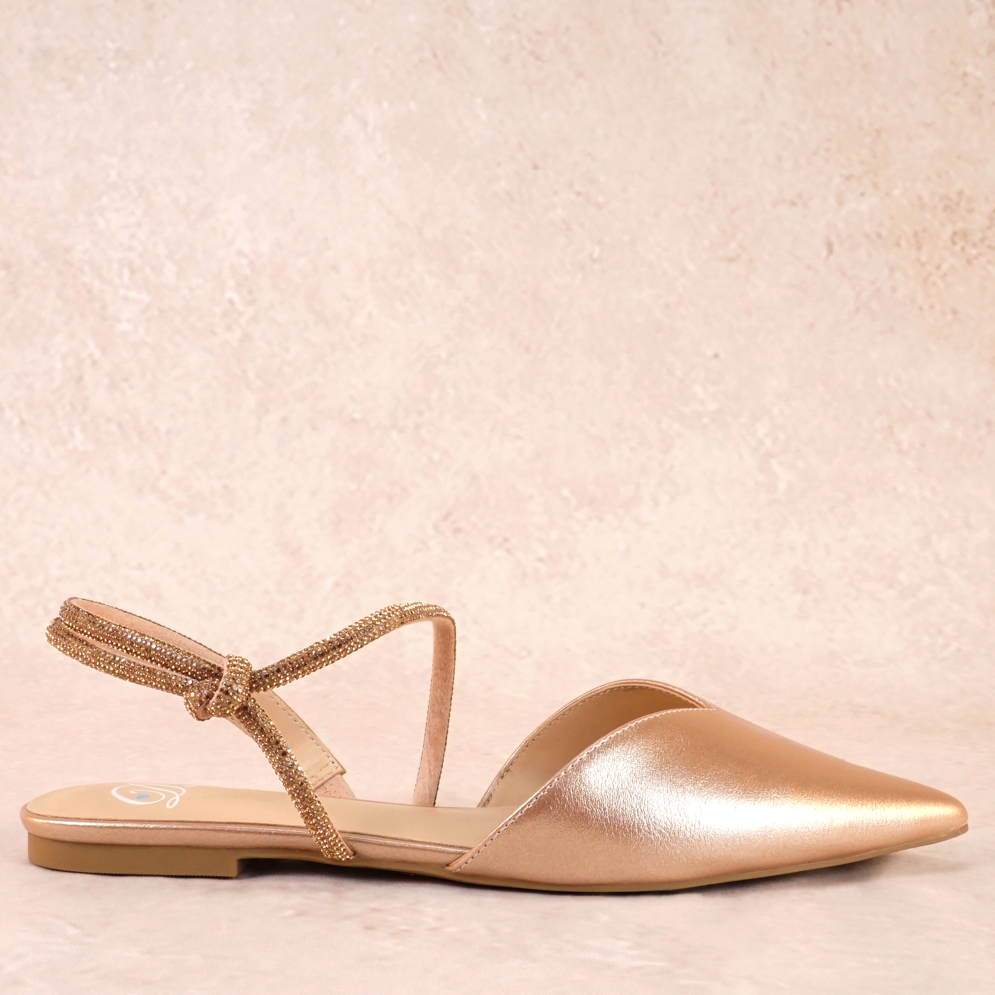 Pointed-toe slingback gold flat with rhinestone strap