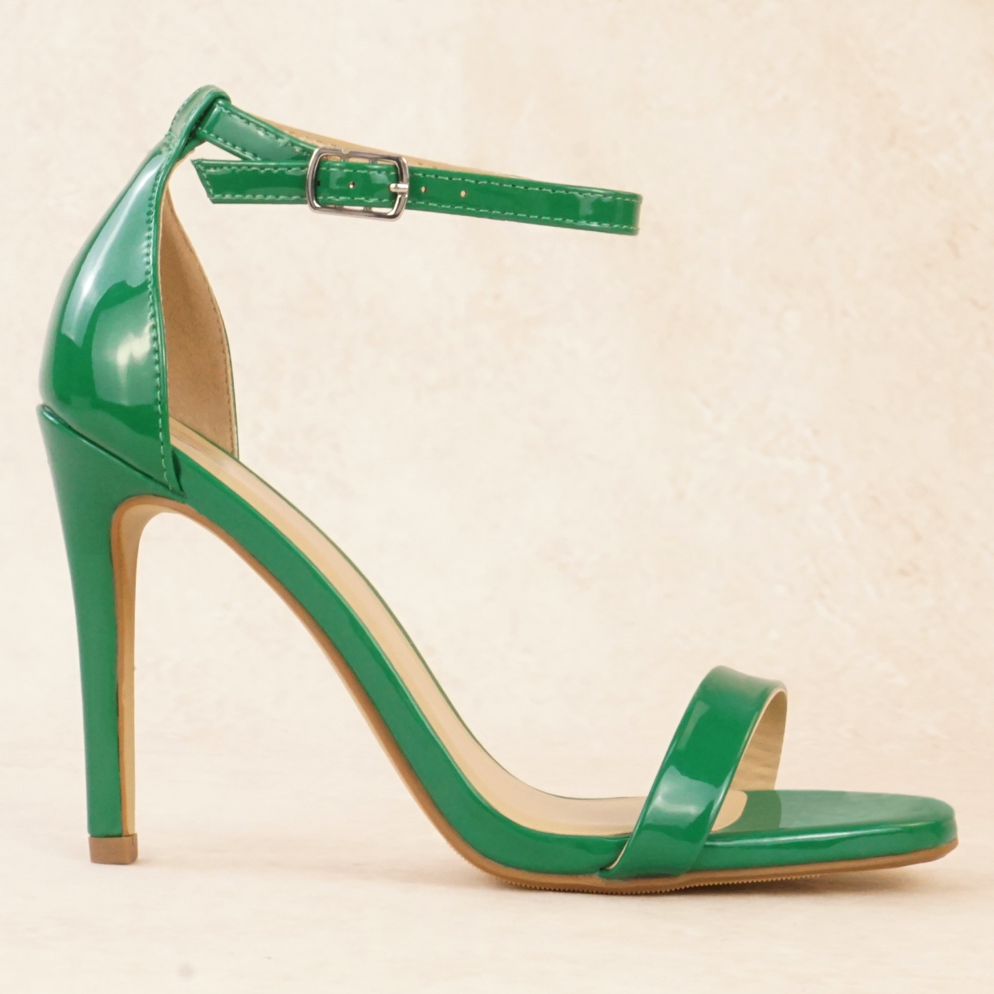 A green patent material stiletto heel with adjustable ankle strap