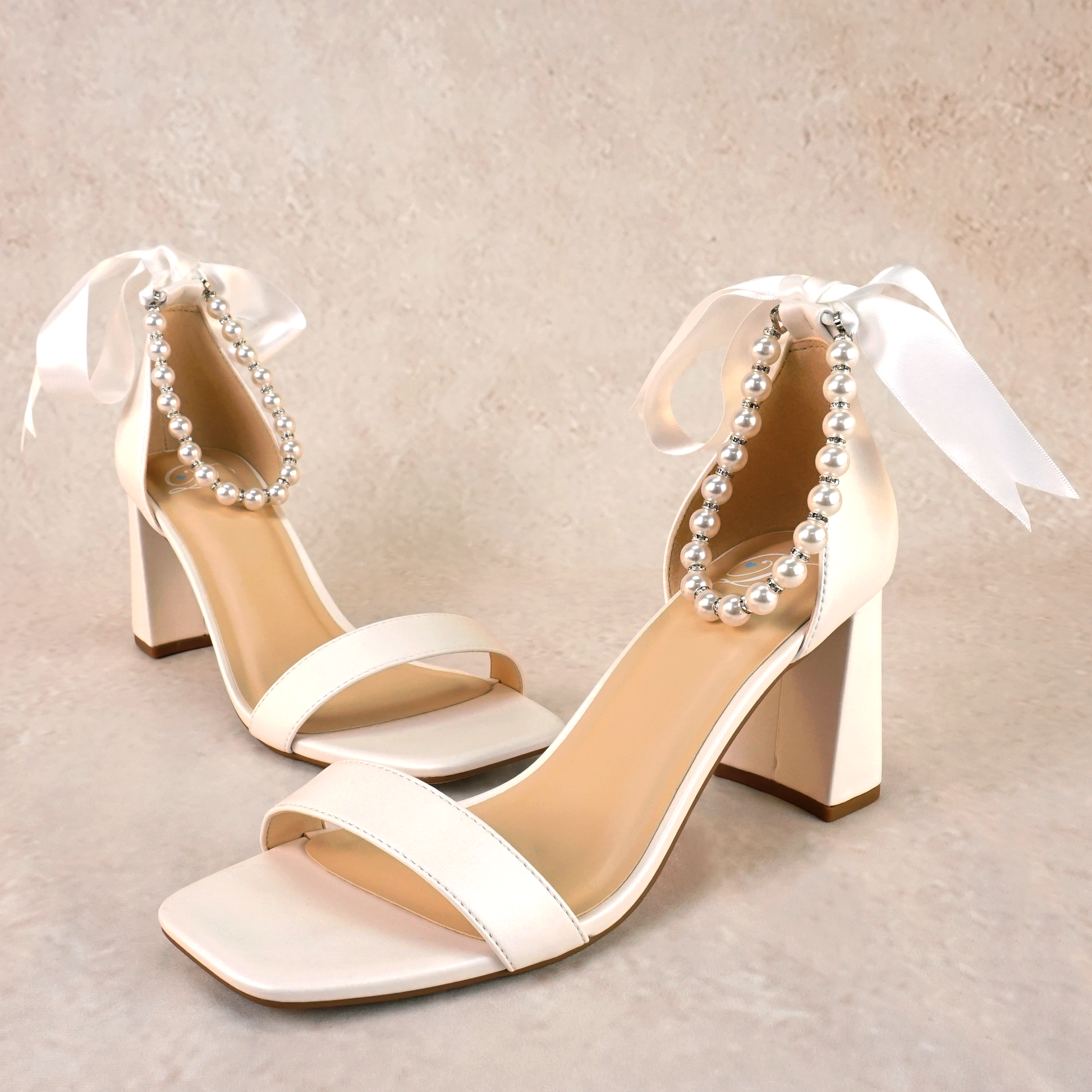 3" flared block heel in white with adjustable pearl ankle strap and satin ribbon tie