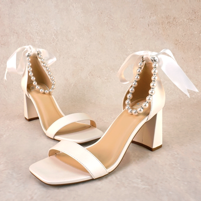 3" flared block heel in white with adjustable pearl ankle strap and satin ribbon tie