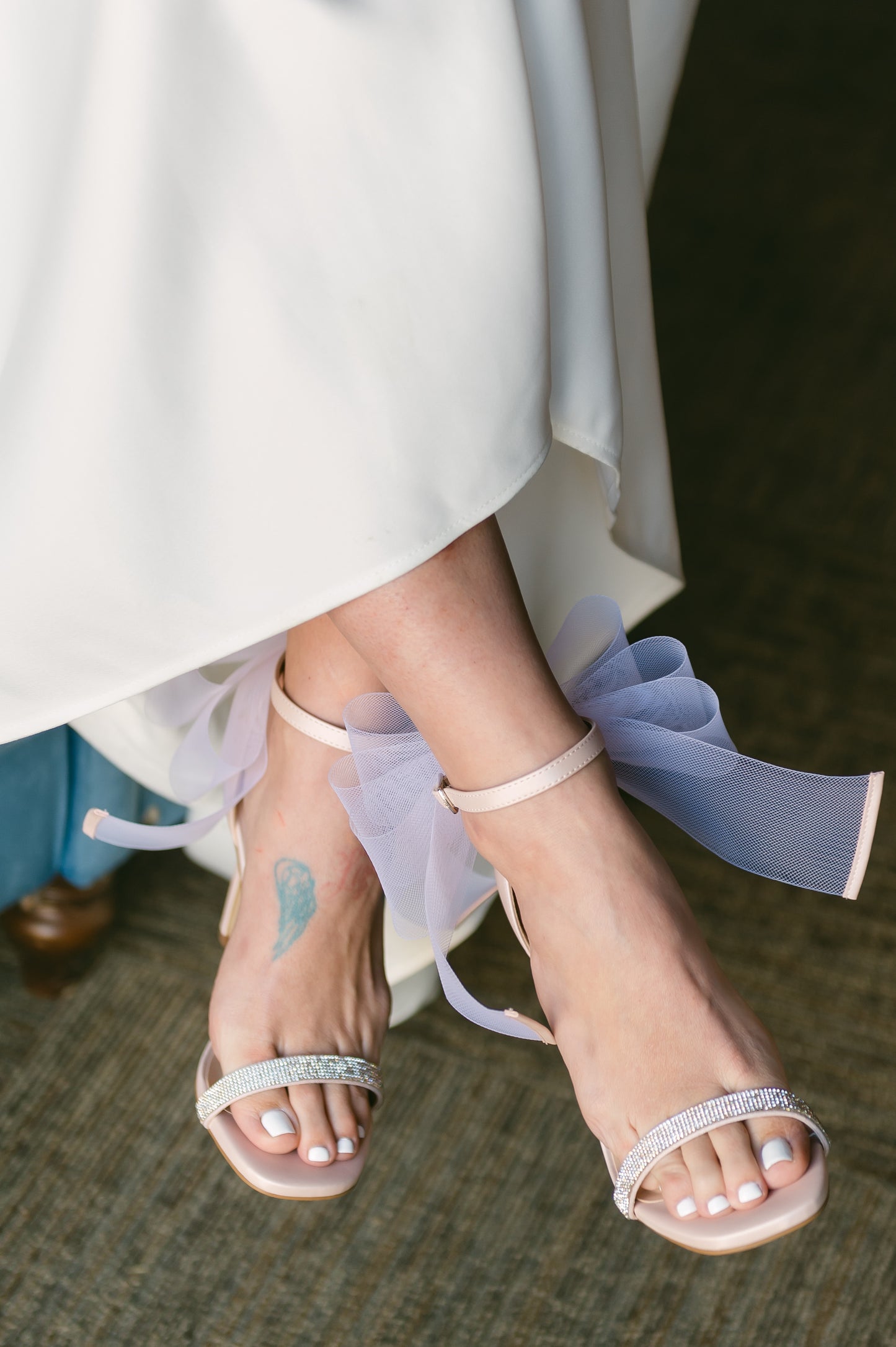 4" stiletto heel in pink with rhinestone band and wire mesh statement bow worn by a woman in a white dress