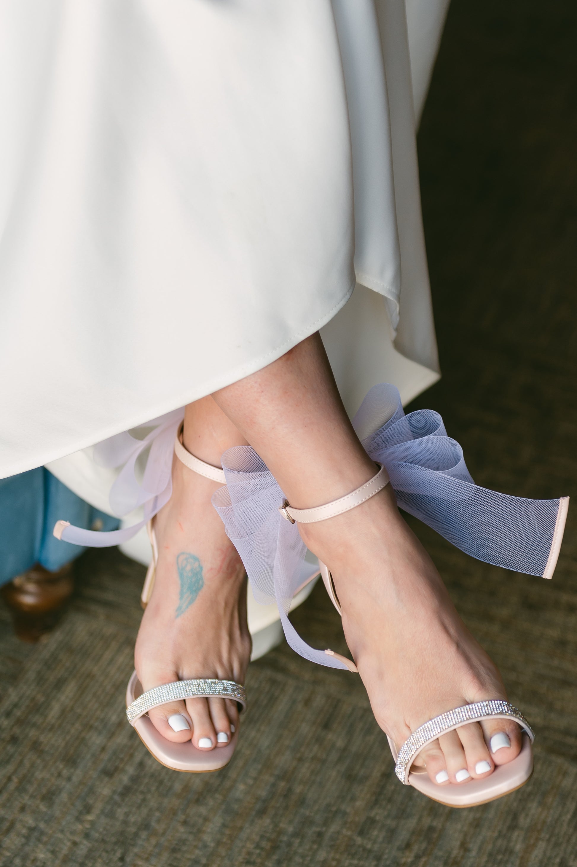 4" stiletto heel in pink with rhinestone band and wire mesh statement bow worn by a woman in a white dress