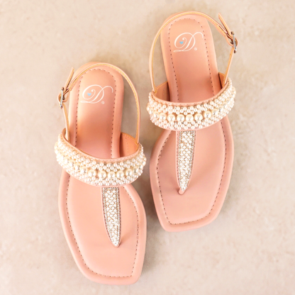 T-strap pink sandals with adjustable slingback and pearl and rhinestone accents