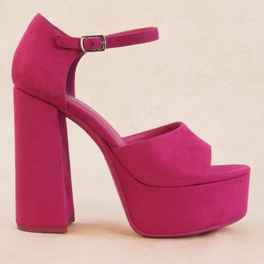 A pink platform high heel with adjustable buckle ankle strap