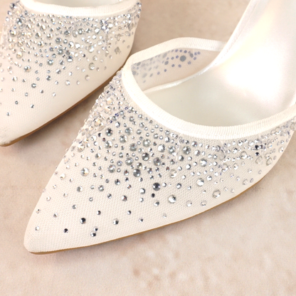 White d’orsay pump with adjustable slingback and a 3.5" heel