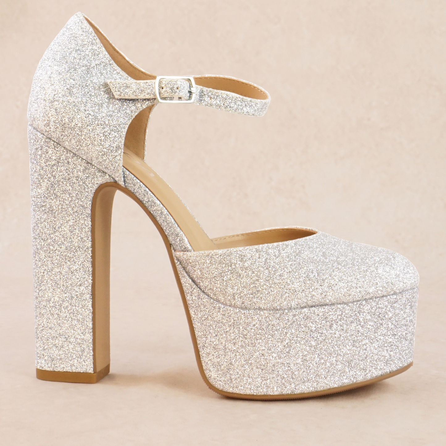 A silver glitter platform high heel with adjustable ankle strap