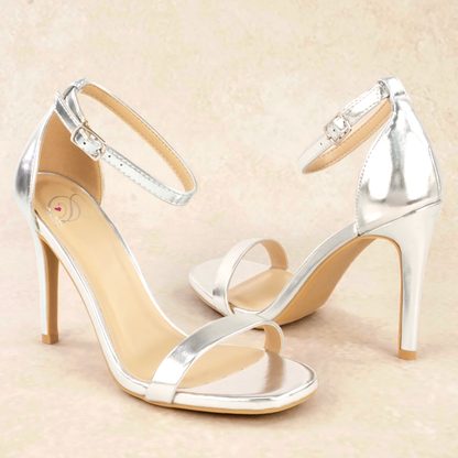 A pair of silver metallic stiletto heels with adjustable ankle straps