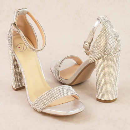 A pair of silver rhinestone high heels with adjustable ankle strap