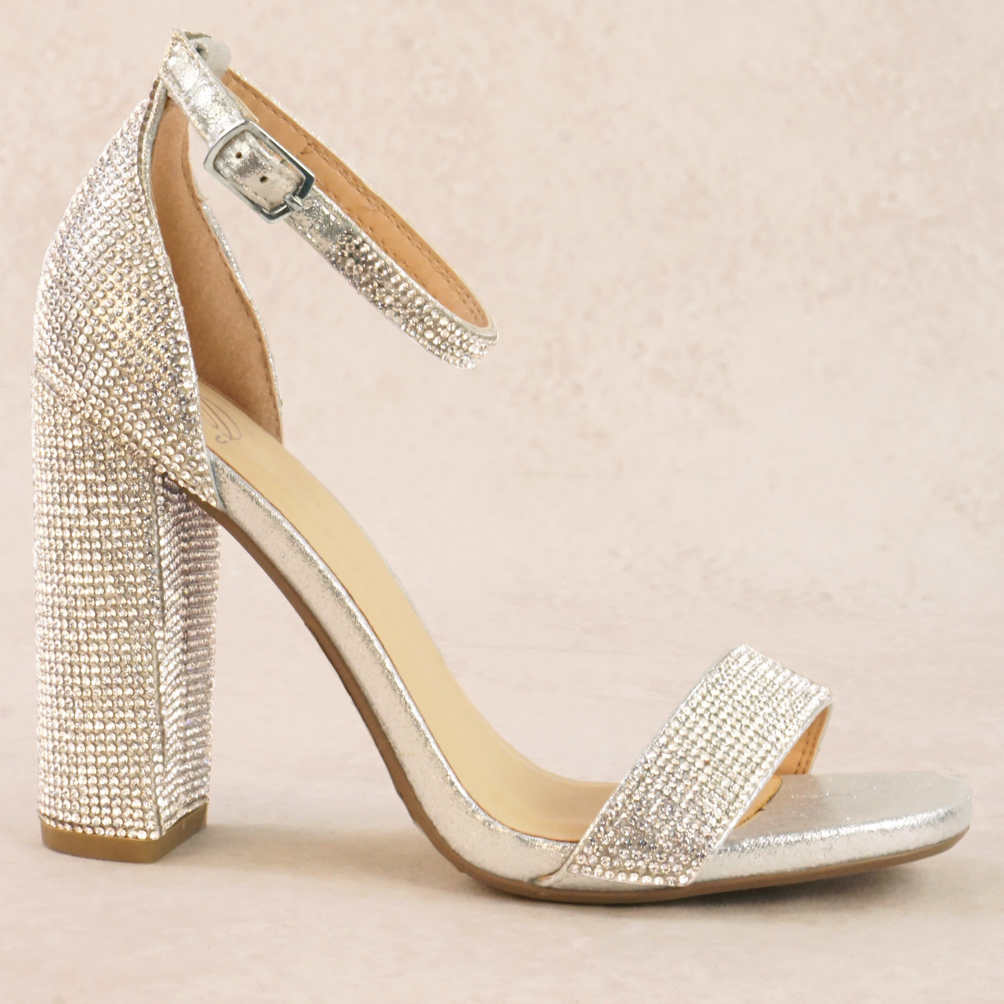A silver rhinestone studded high heel with adjustable ankle strap