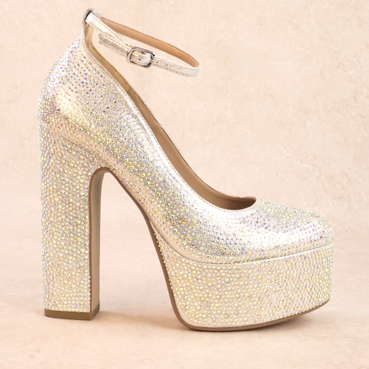 A silver rhinestone studded platform high heel with adjustable ankle strap