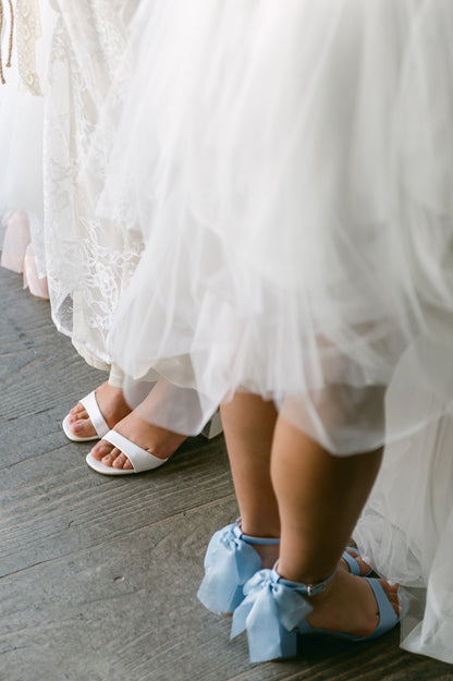 Simple low 2.5" block heels in white and blue with a bow at the back