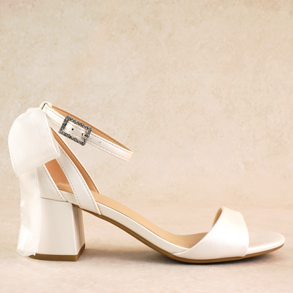 Simple low 2.5" block heel in white with a bow at the back