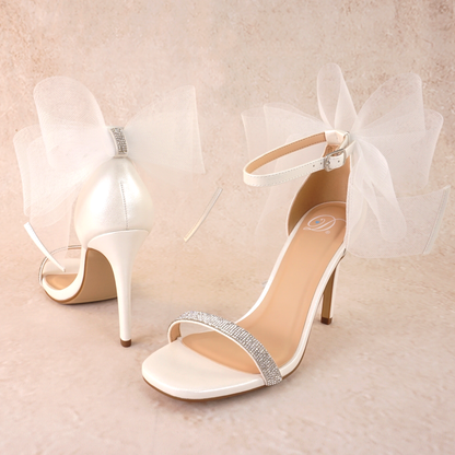 4" stiletto heel in white with rhinestone band and wire mesh statement bow