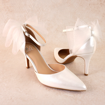 White d’orsay pump with ankle strap bow detail and a 3.25" stiletto heel