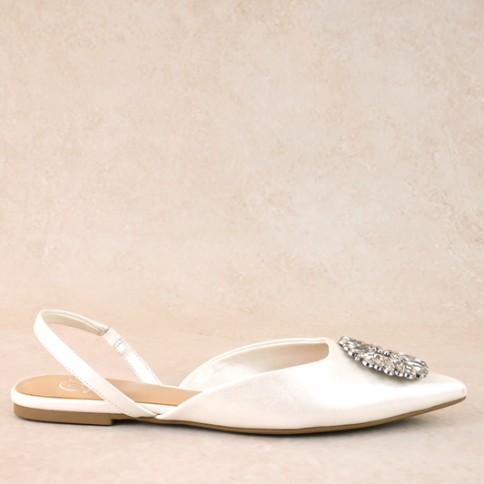 White pointed-toe slingback flat shoe with rhinestone accent