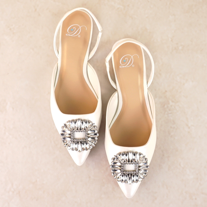 White pointed-toe slingback flat with rhinestone accent