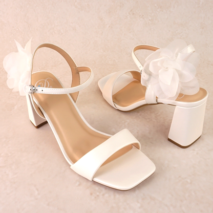 Flared 3" block heel in white with slim ankle strap and flower detail 